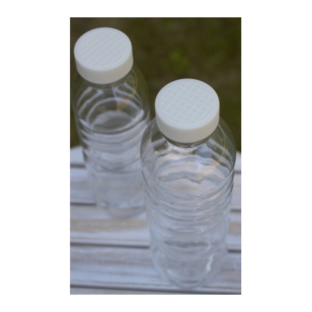 two_pure_bottle_white_flower_of_life_on_table_outside_bioplastic_lid_500ml_natures_design_serenity_plus